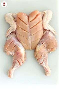 the chicken is cut in half and ready to be cooked