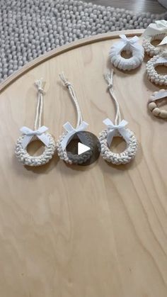 several pieces of jewelry sitting on top of a wooden table in front of a rug