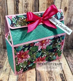 a card box with a red bow on the top and some flowers around it that says mixed up craft