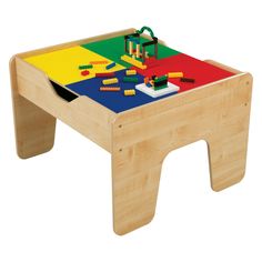 a child's wooden toy table with legos on the top and bottom surface