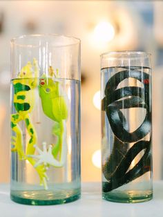 two glass vases with different types of animals in them