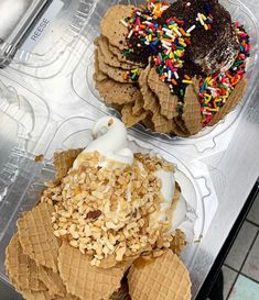 two desserts in plastic containers with sprinkles and toppings on them