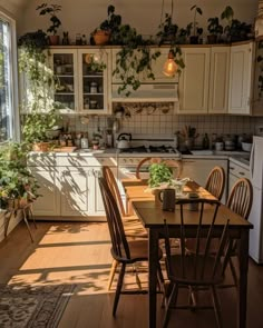 a kitchen filled with lots of wooden furniture and plants on the wall above the table