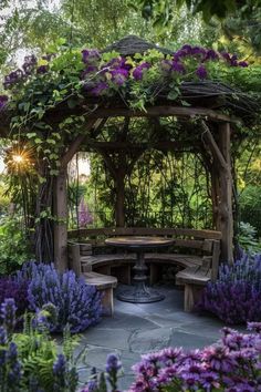 a wooden gazebo surrounded by purple flowers and greenery