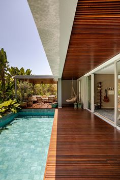 an outdoor swimming pool next to a wooden deck