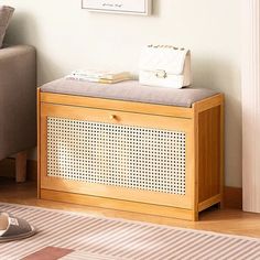 a white purse sitting on top of a wooden bench next to a gray and white rug