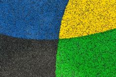 an abstract photo of grass and blue, black, yellow and green colors with small speckles