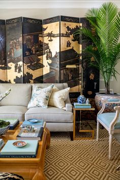 a living room filled with furniture and paintings on the wall