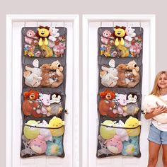 a woman holding a stuffed animal in front of two wall hangings with teddy bears on them