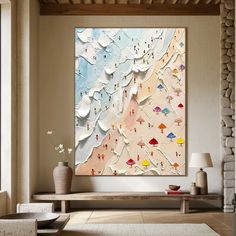 an abstract painting hangs on the wall in a living room