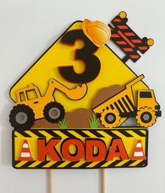 a construction themed birthday cake topper with the number 3 on it