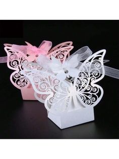 two small white boxes with pink bows and butterflies on the top, one is open