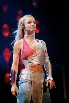 a woman in metallic outfit standing on stage