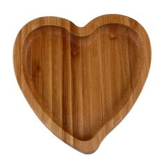 a heart shaped wooden cutting board on a white background