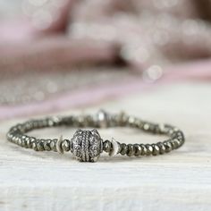 This pyrite and silver stretch bracelet is the epitome of earthy elegance - perfect for those who like to make a natural, slightly edgy statement. It makes an excellent gift for a loved one, a family member, a friend or co-worker, especially if they like to wear their bracelets stacked. Fantastic worn alone or added to a stack, to which it will bring a fabulous textural element. This mixed metal bracelet is handmade from faceted pyrite beads which sparkle like diamonds. Set in the middle is a gr Edgy Bracelets, Mixed Metal Bracelet, Bracelets Stacked, Mixed Metal Bracelets, Pyrite Bracelet, Earthy Elegance, Edgy Jewelry, Bracelet Stacking, Mixed Metal Jewelry