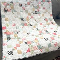 a quilt is on the back of a couch