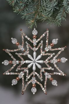 a snowflake ornament hanging from a tree