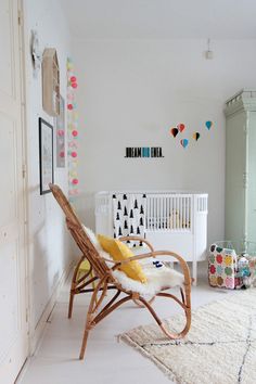 a baby's room with a white crib and colorful decorations