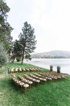 rows of chairs set up for an outdoor wedding ceremony by the water's edge