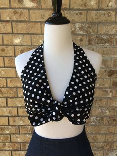 a black and white polka dot halter top on a mannequin headdress