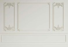 an empty room with white walls and decorative moldings