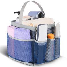 a blue and gray bag filled with lots of items on top of a white surface