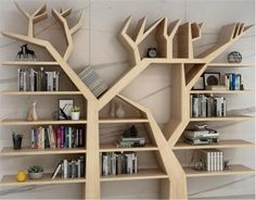 the bookshelves are made out of wood and have tree branches on them,