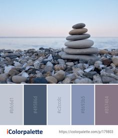 rocks stacked on top of each other in front of the ocean with color palette swatches