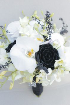 a bridal bouquet with white and black flowers