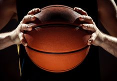 a person holding a basketball in their hands