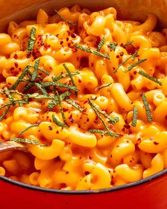 a red pot filled with macaroni and cheese