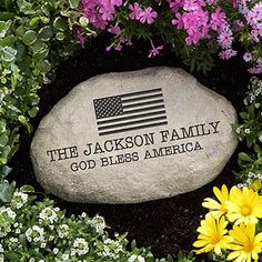 a rock with the words, the jackson family god bless america on it surrounded by flowers