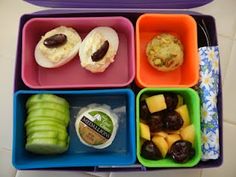 a lunch box filled with different types of food and fruit in it's compartments