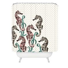 a shower curtain with seahorses on it and polka dot dots in the background