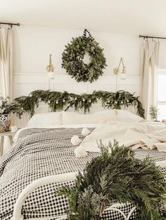 a black and white checkered bedspread with wreaths on the headboard