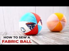 two colorful balls sitting on top of a wooden table with text overlay how to sew a fabric ball