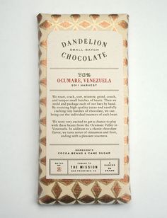 a bar of chocolate that is sitting on a white surface with an orange and brown pattern