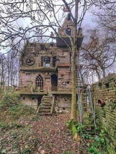 an old abandoned house in the woods with stairs leading up to it's windows