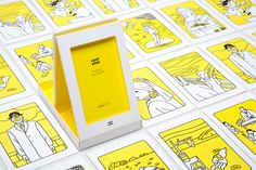 an open box sitting on top of a table filled with yellow and white paper cut outs