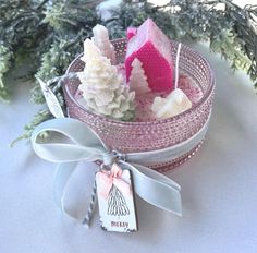 a pink and white bath bomb sitting on top of a table next to a christmas tree