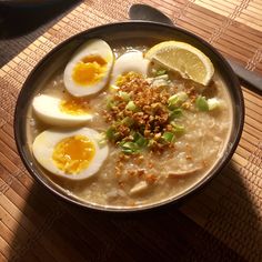 a bowl of soup with hard boiled eggs and garnish