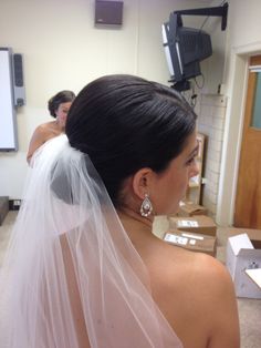 the back of a bride's wedding dress in a room with boxes on the floor