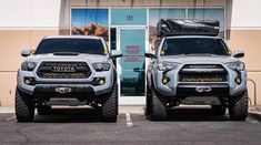 two trucks parked in front of a building