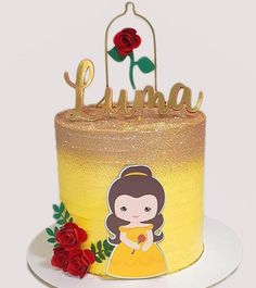 there is a yellow cake with a princess on it and red roses around the edges