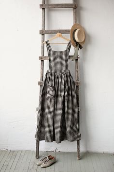 "Cottage dress is made from 100% soft and washed linen.  Details: - Colour: Black gingham - Composition: 100% Oeko-Tex certified linen - Pockets - Cross back - Adjustable with buttons - Elastic waist - Medium weight linen - Linen care: machine wash gentle; tumble dry low, ironing optional - The price is for one cottage dress, other pictured items are not included The model is 170 cm/5'7\" and wears a size XS." Victorian Apron, Victorian Aprons, Linen Pinafore Dress, Cottage Dress, Japanese Sewing Patterns, Linen Pinafore, Sewing Projects Clothes, Black Gingham, Elastic Waist Dress