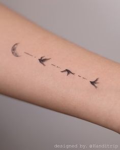 a woman's arm with three birds flying in the sky and half moon on it