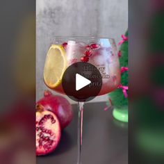 a wine glass filled with pomegranate and lemon