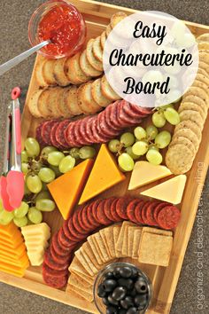 an easy charcuterie board with cheese, crackers and grapes