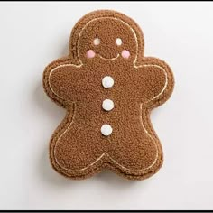 a cookie shaped like a ginger with white dots