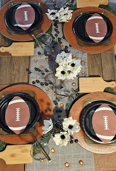 the table is set with plates and place settings for an american football themed dinner party